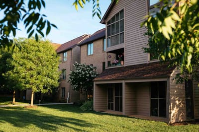 Exterior view of a senior living building with trees