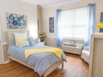 A bright, cozy resident room with blue decor