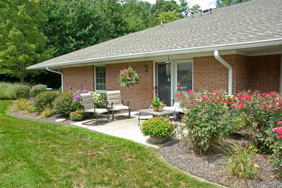 Outdoor seating area with flowers and greenery