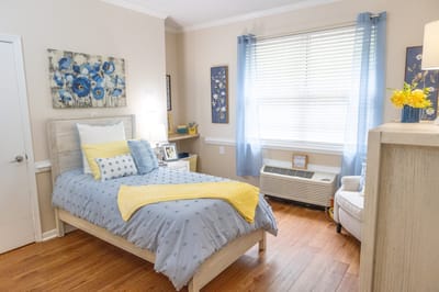Cozy resident room with light decor and comfortable furnishings