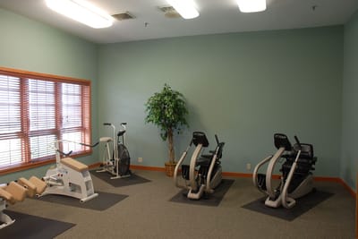 Fitness equipment in a well-lit exercise room