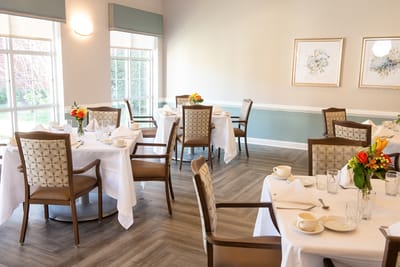 Dining room setup with floral centerpieces