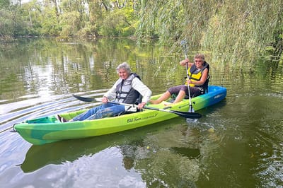 Two residents kayaking on a serene lake