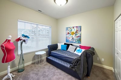 Cozy interior of a resident's room with a sofa and artwork