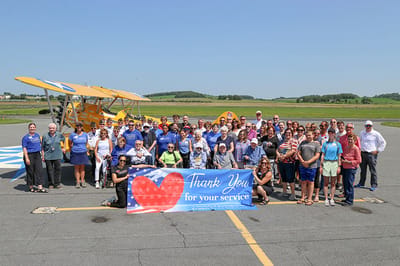 Group of people holding a banner at an outdoor event