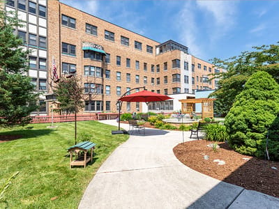 Outdoor seating area with landscaping near the facility