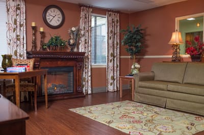 Cozy lounge area with a gas fireplace and decorative plants