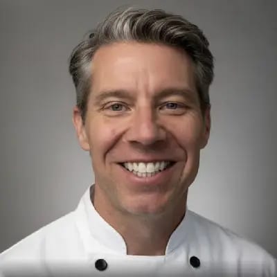 Smiling chef in a white uniform