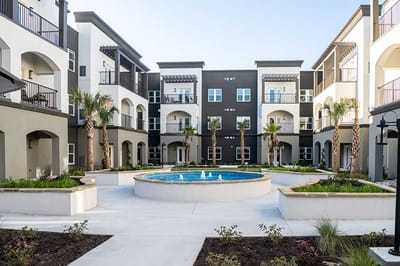 Courtyard with a fountain and surrounding apartments