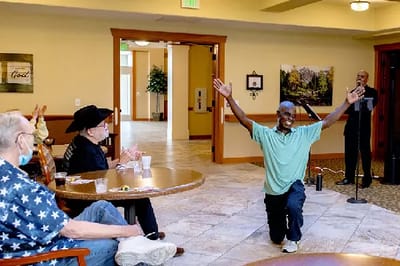 Residents enjoying a performance in a common area