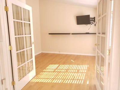 Bright and spacious interior room with wooden flooring