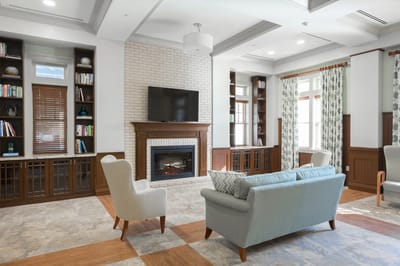 Well-lit common area with a fireplace and comfortable seating