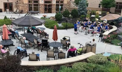 Residents enjoying live music in the outdoor courtyard