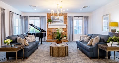 Bright and inviting common area with piano and seating
