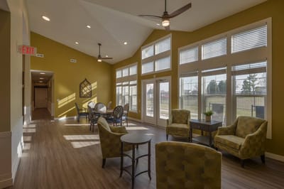 Bright common area with seating and large windows