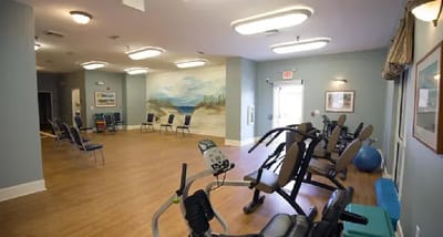 Interior fitness area with exercise equipment and chairs