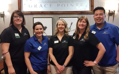 Staff members posing in the facility's lobby area