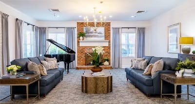 Bright common area with seating and a piano