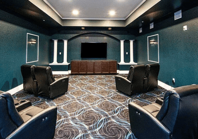 Cozy common area with theater seating and large screen