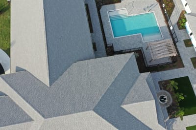 Aerial view of a swimming pool and surrounding buildings