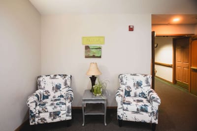 Cozy sitting area with floral chairs and lamp