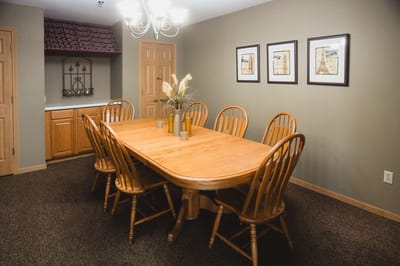 Bright dining area with a wooden table and chairs