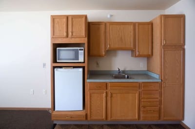 Kitchen area with wooden cabinets and appliances