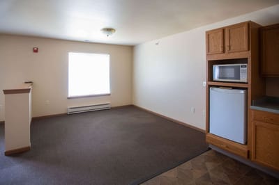 Interior view of a senior living unit kitchen and living area