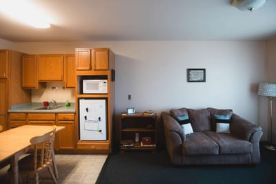 Cozy resident room with kitchen area and seating