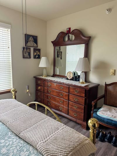 Cozy bedroom with wooden furniture and personal touches