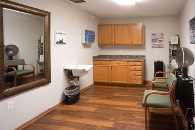 Interior of a salon room with chairs and a mirror