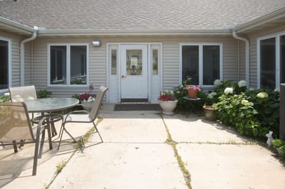 Outdoor patio area with seating and flowers