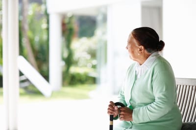 Resident enjoying the view in a bright common area