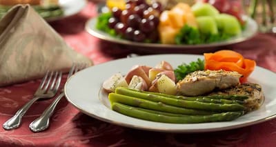 A beautifully plated meal with grilled chicken and vegetables