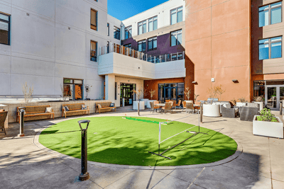 Outdoor space with green lawn and seating areas