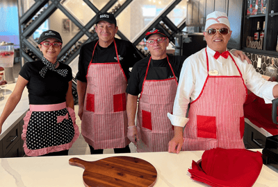 Staff members in the kitchen wearing aprons
