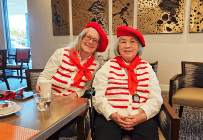 Residents celebrating in a common area, dressed in themed outfits