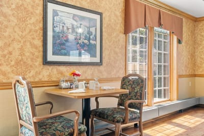 Dining area with a table and floral artwork