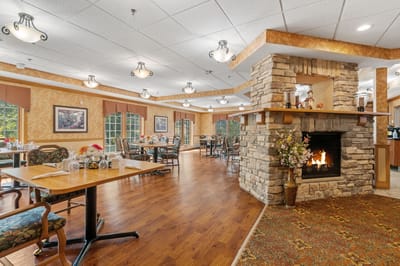 Bright dining room with fireplace and tables