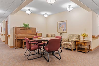 Cozy common area with seating and a piano