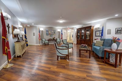 Common area with seating and decor in a senior living facility