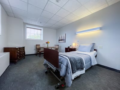 A private resident room with a bed and furniture