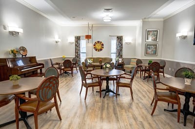 Common area with seating and piano in a senior living facility