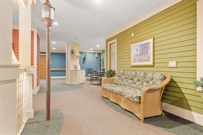 A cozy common area with seating and a decorative lamp