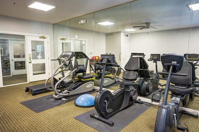 Fitness area with exercise equipment and mirrors