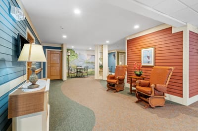 Interior view of a common area with armchairs and a mural