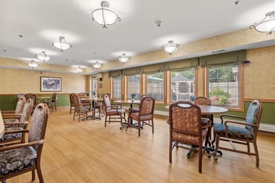 Common area with tables and chairs for residents
