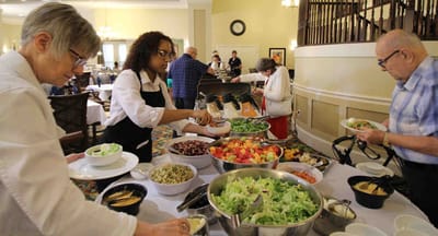 Residents enjoying a meal service in the dining room