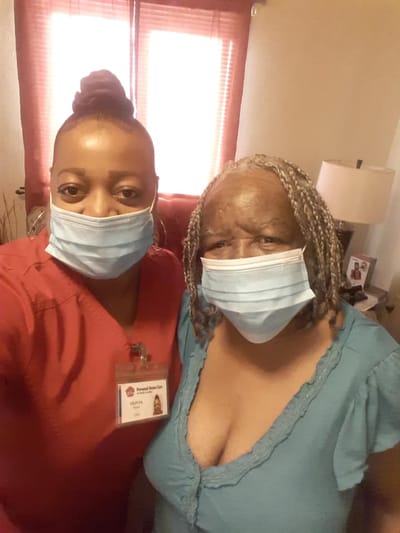Healthcare worker and resident posing together