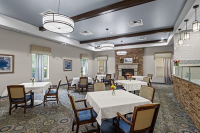 Bright dining room with tables set for meals